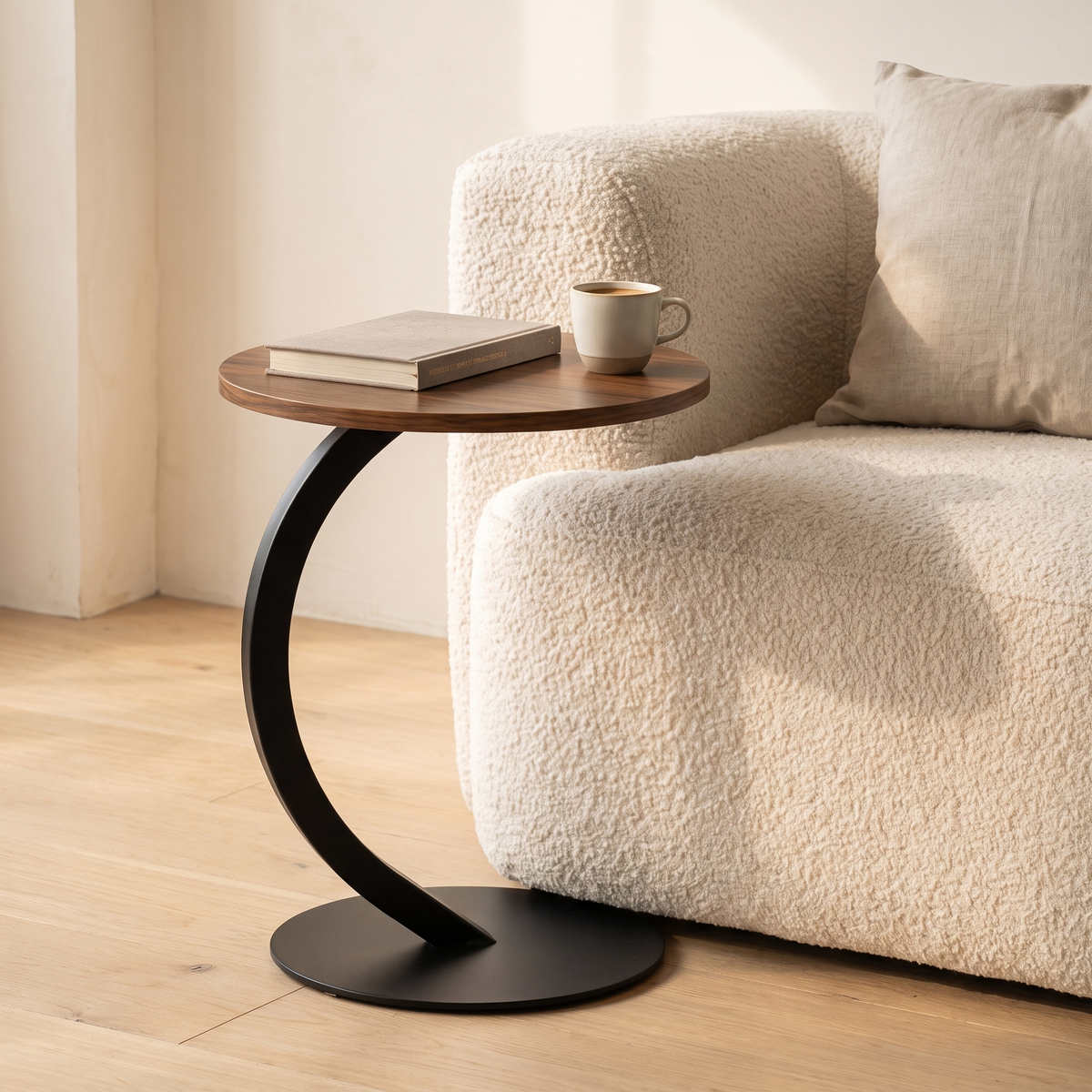 Orla Curve Side Table in walnut effect with black frame beside a sofa