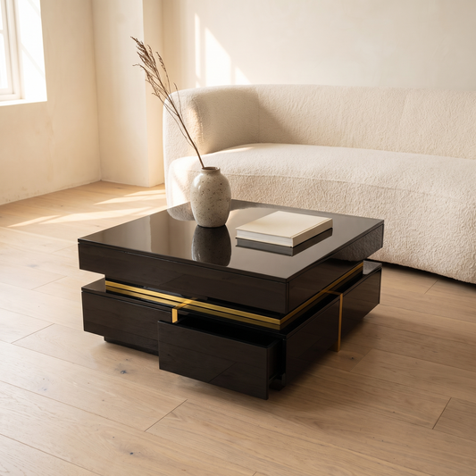 Nova Gloss Coffee Table in black high gloss with gold trim beside a cream sofa