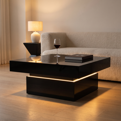 Luma Gloss Coffee Table in black with the LED strip glowing amber in the evening