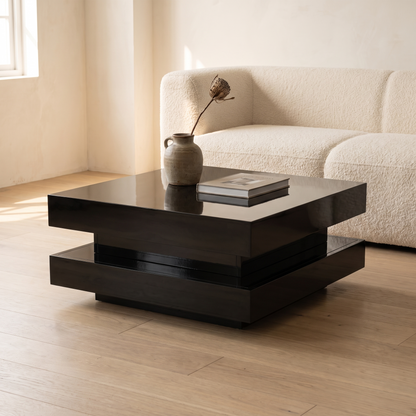 Luma Gloss Coffee Table in black high gloss beside a cream sofa