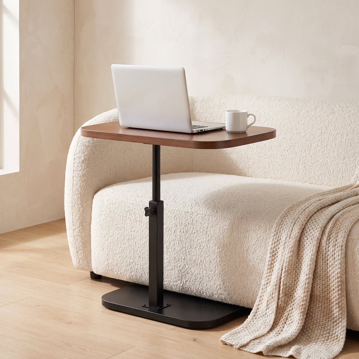 Ezra side table raised as a laptop table over the sofa
