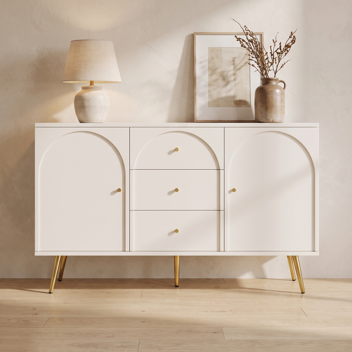 Elodie Arched Sideboard in cream white with gold legs, styled with a lamp and vase