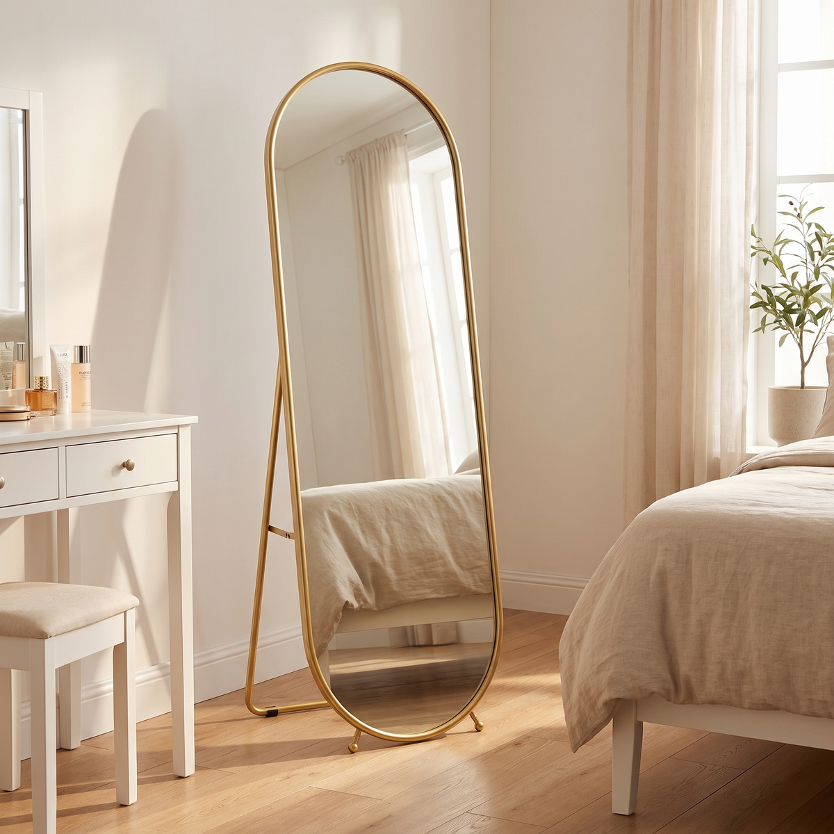 Celia gold oval full length mirror in a bedroom